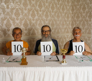 Three Smiling Judges Holding up Perfect Ten