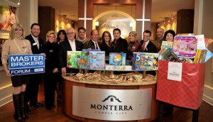 Members of the Broward MBF Advisory Board, with new toys donated to the Pantry of Broward by Master Brokers.