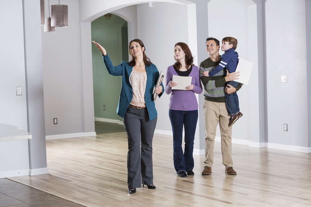 Young family with real estate agent at an open house.